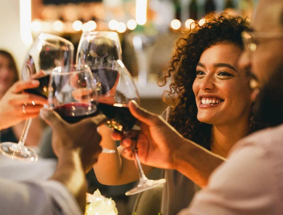 Friends clinking wine glasses