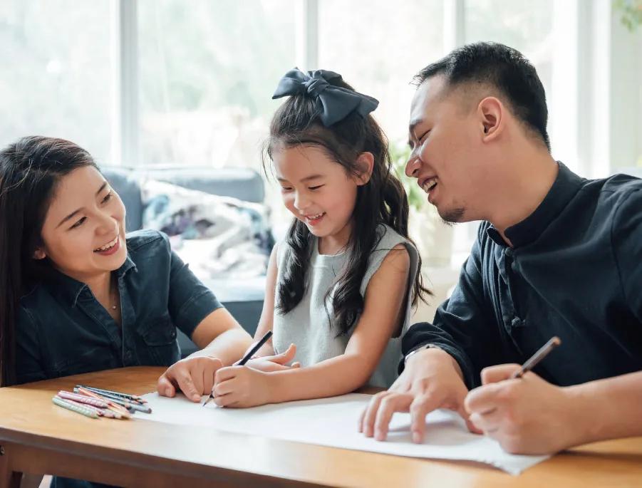 Parents and their child drawing together